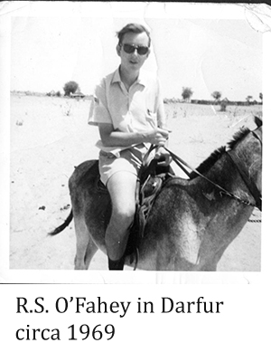 young man riding a donkey in Darfur
